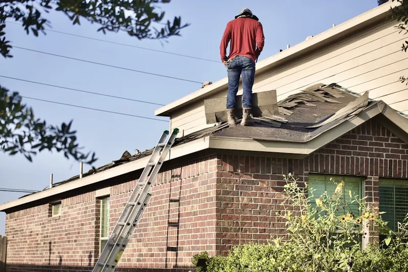 Professional roofer working on a residential roof in Covington Park